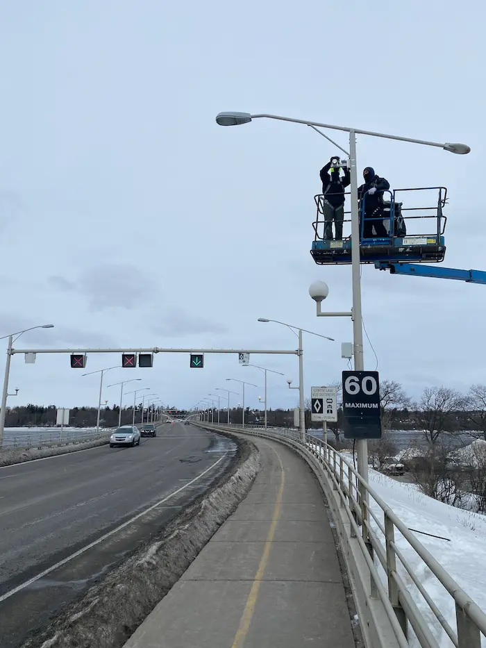 Technician installing a tamper-resistant people counting sensor during professional commissioning — Smart Sensor Solutions